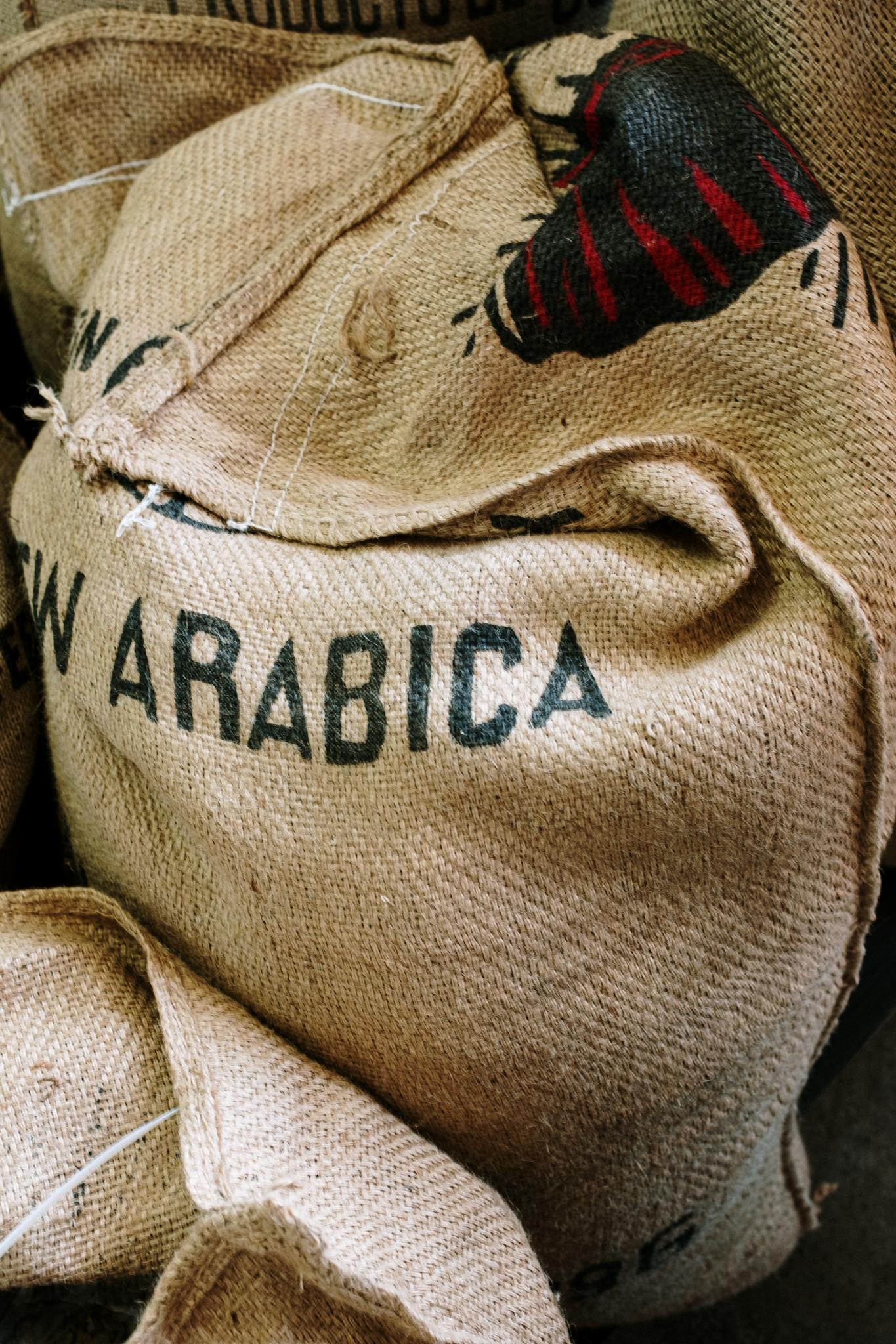 Detailed image of a burlap sack labeled with Arabica coffee beans.
